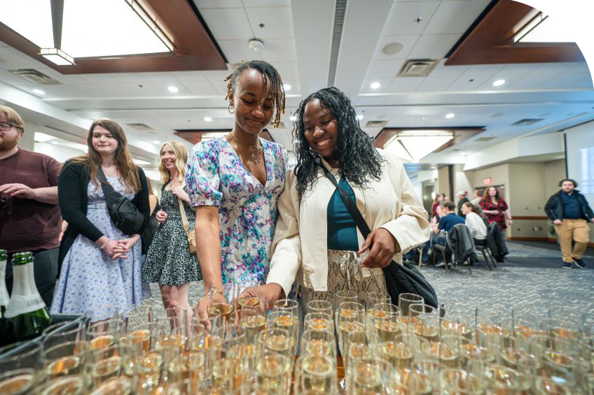 graduates getting their champagne for senior toast